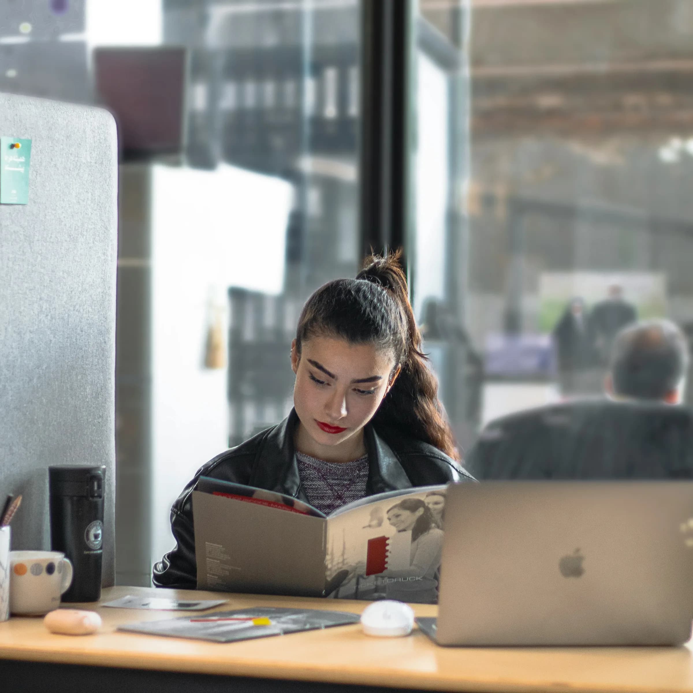 An adult learner studying at a laptop at a kitchen table