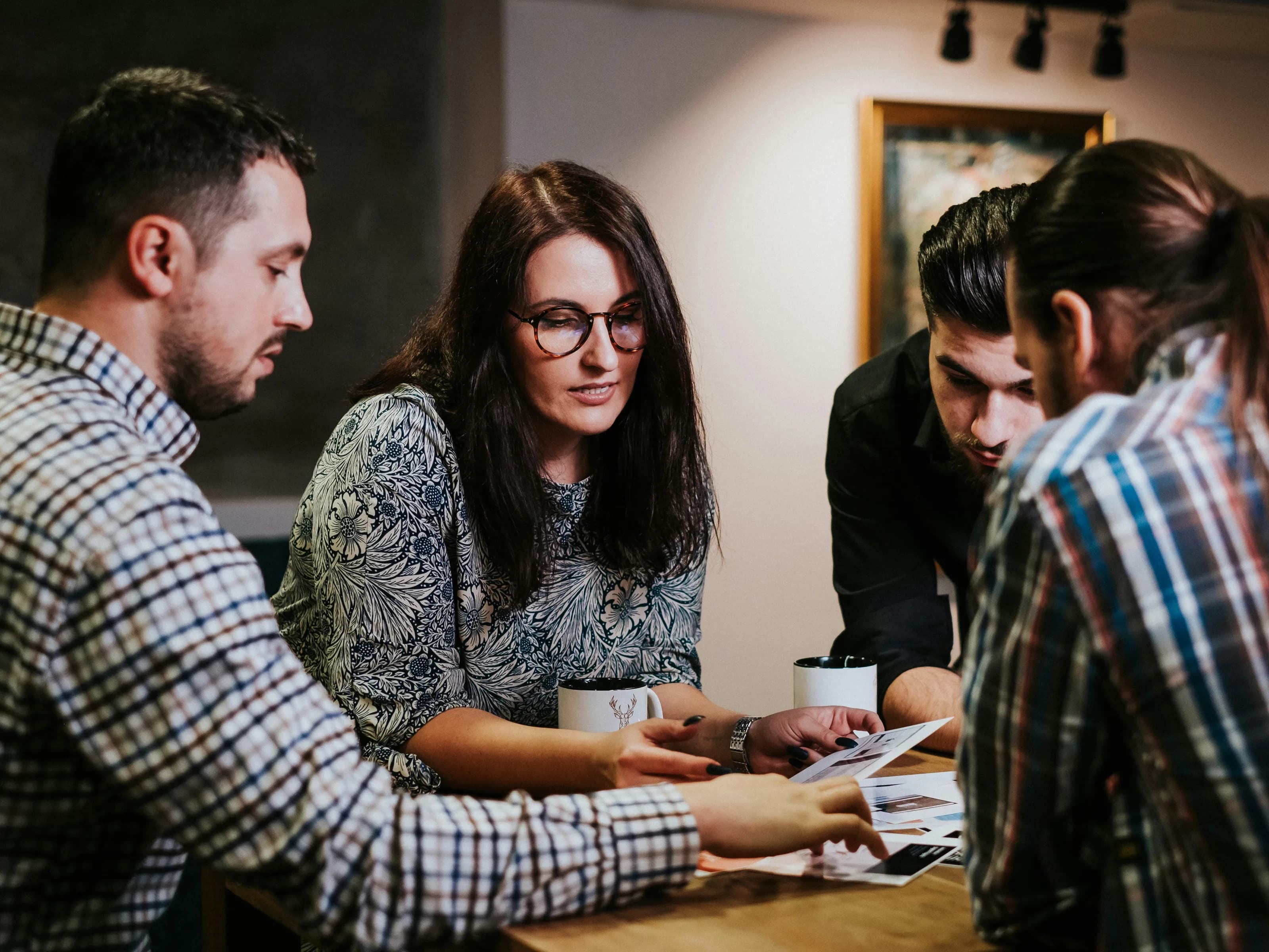 Two Parseh advisers talking with a student across a table