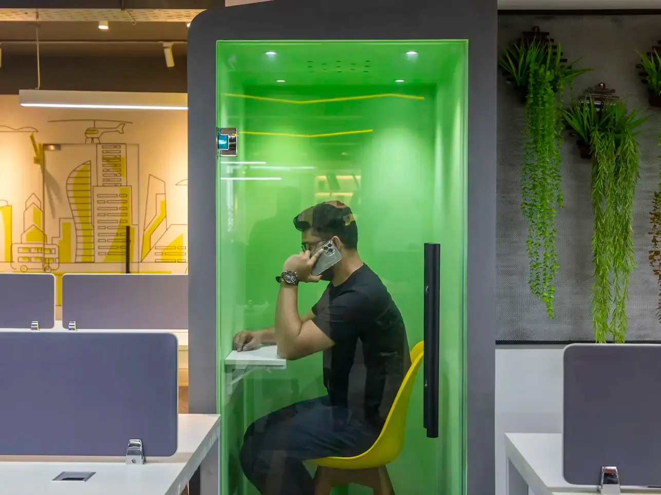 A Parseh adviser at a desk, on a call