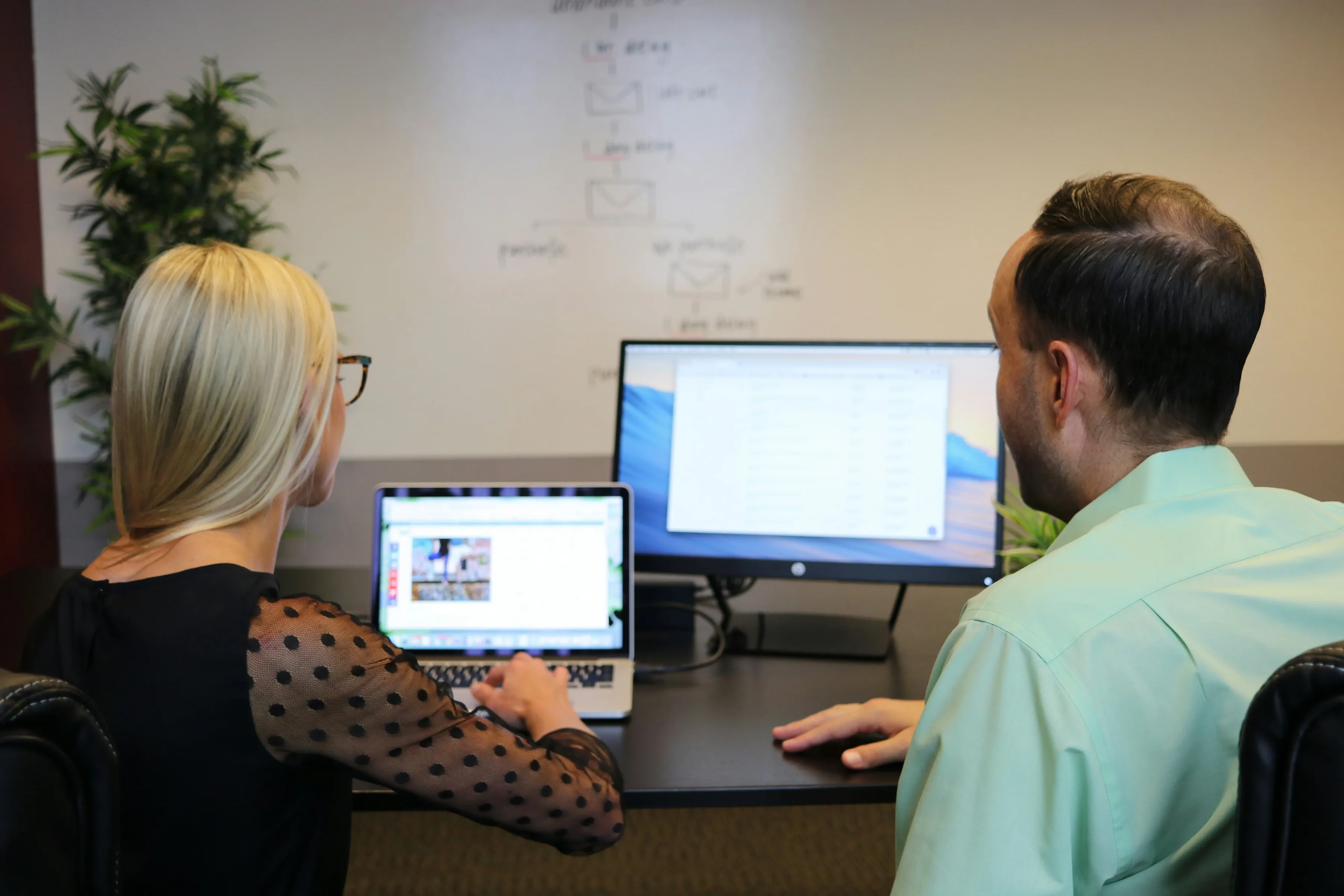 An adviser and a student looking at a shortlist of courses together